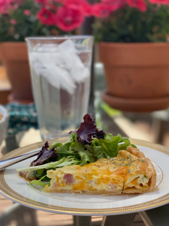 Quiche with salad and iced water