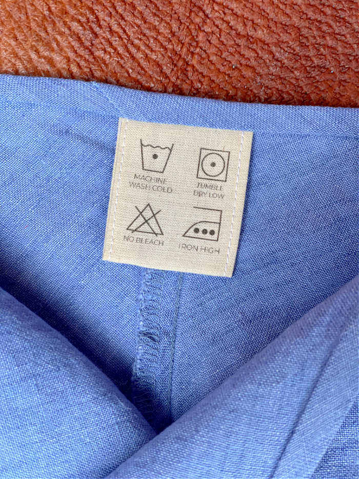 Photo of cotton care label in a blue shirt collar