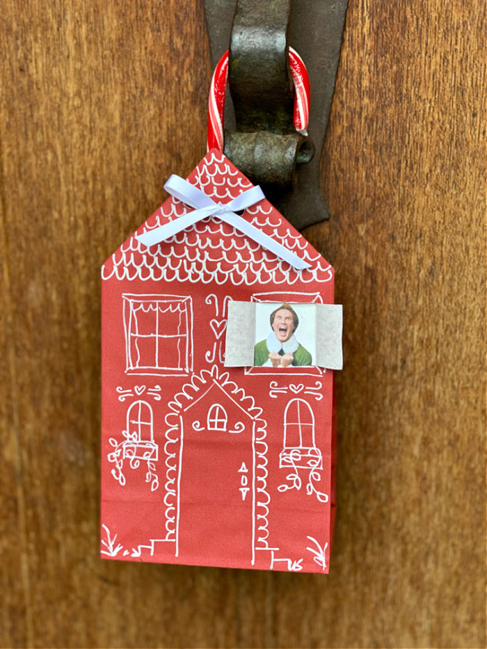 Photo of red paper bag house hanging on a front door