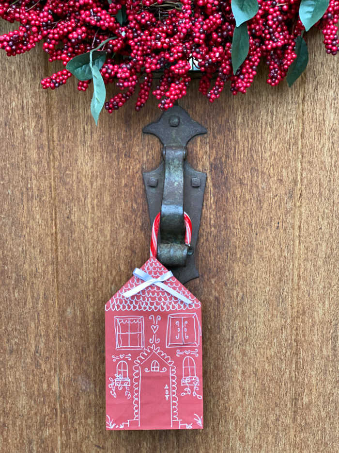 Photo of red paper bag house hanging on a front door