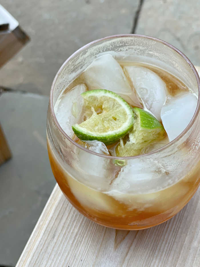 Photo of dark and stormy cocktail with lime garnish