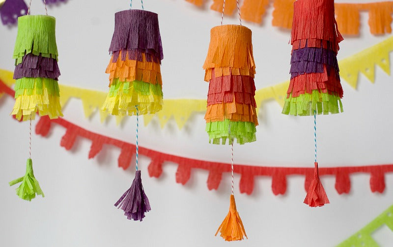 Click through to try this easy pinata garland using toilet paper rolls and crepe paper | Easy Cinco De Mayo party decorations | SatsumaDesigns.com #party #CincoDeMayo