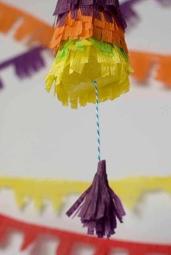 Click through to try this easy pinata garland using toilet paper rolls and crepe paper | Easy Cinco De Mayo party decorations | SatsumaDesigns.com #party #CincoDeMayo