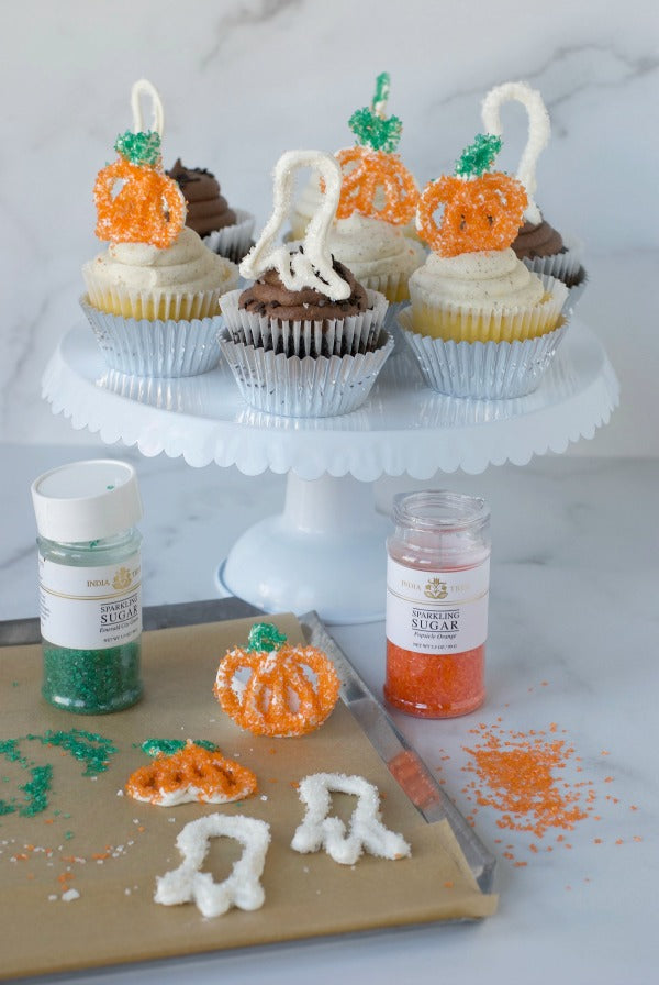 Halloween sprinkle cupcake toppers made from candy melts and decorated with sanding sugar take just minutes to make and leave a big impression! Perfect for Halloween parties #halloween #partyplanning #pumpkins #ghosts #cupcakes #candymelts #dessert