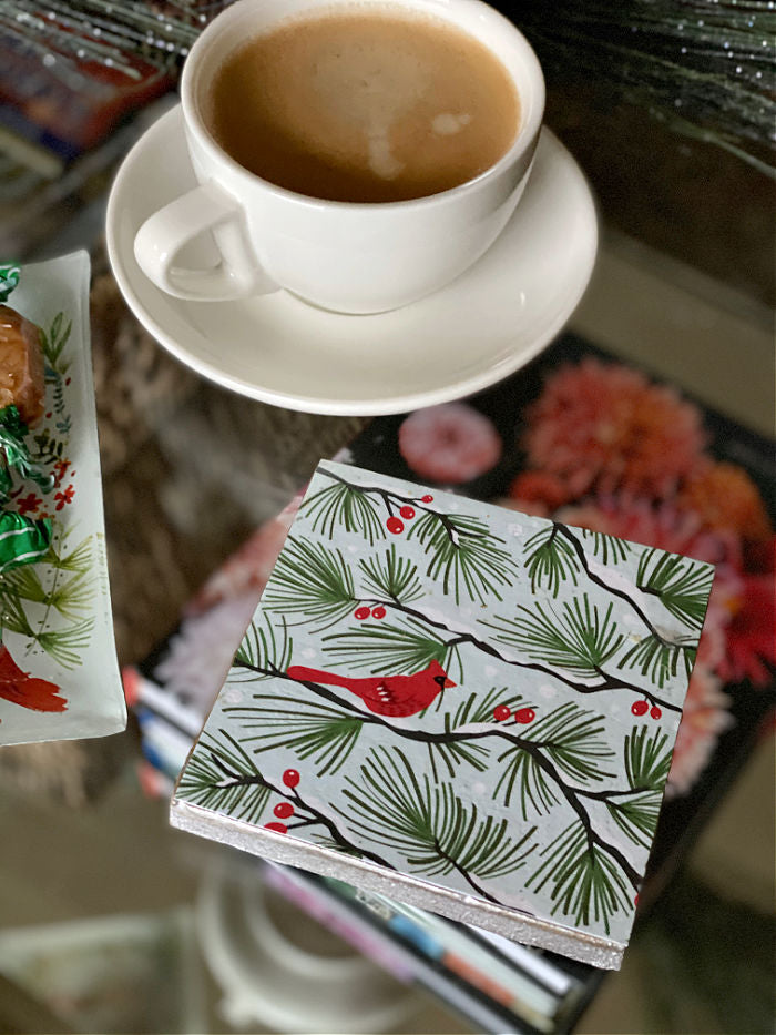 Discover how to upcycle holiday cards into coasters and trivets for gift giving, entertaining and holiday cooking. Enjoy this easy craft to try with the kids too! #holiday #upcycle #holidaycards #recycle #familytime