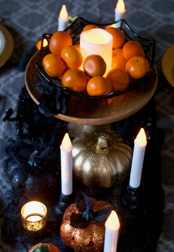 Orange black and gold Halloween tablescape for holiday feasts. Try this easy to assemble tablescape for Halloween parties or to enjoy throughout the season | #halloween #satsumadesigns #partyplanning #dollarstore #layereddesign