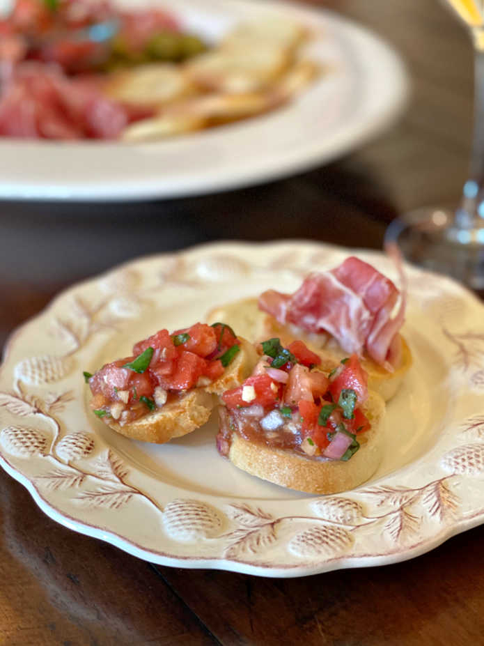 Photo of tomato bruschetta on a small serving plate