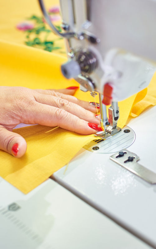 Photo of hand sewing yellow fabric
