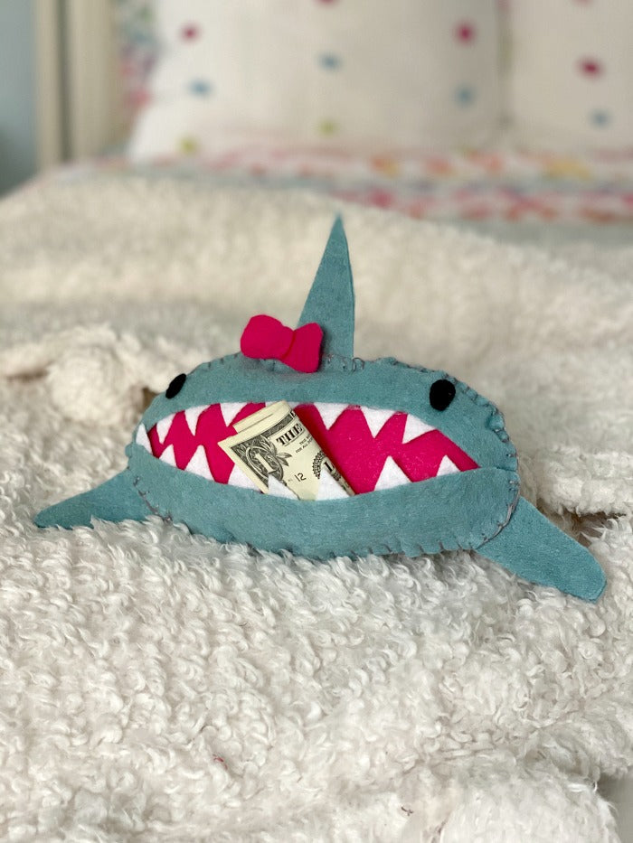 Sew easy shark tooth fairy pillow is the perfect project for little hands. Try this tooth fairy pillow with kids who are learning to sew. Or bypass needle and thread and simply use a glue gun to complete! #toothfairy #kids #sewing #beginnersewing #embroidery #blanketstitch #craft #crafty #crafts #feltcrafts