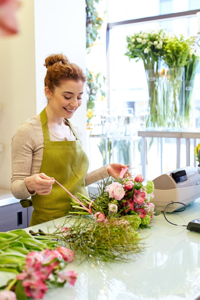 woman arranging flowers at a shop