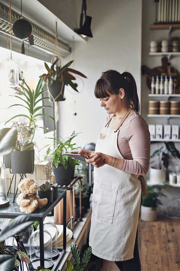 Woman in gift shop working on ecommerce planning
