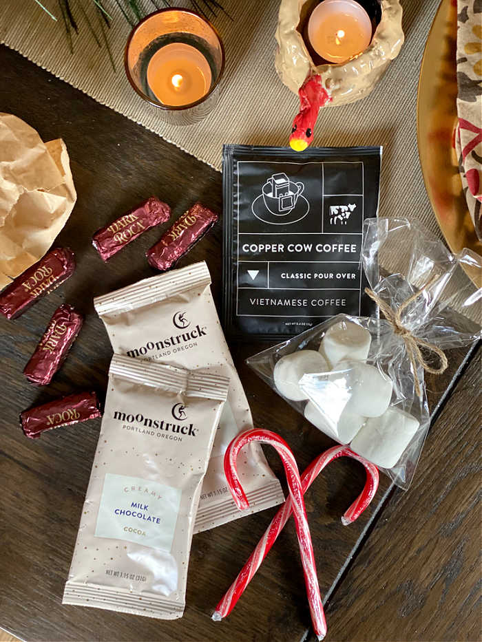 Hot cocoa and coffee packets with marshmallows and candy canes