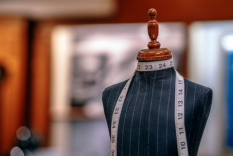 Inches tape on a dummy in tailor shop