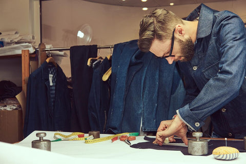 a tailor working on a piece of cloth