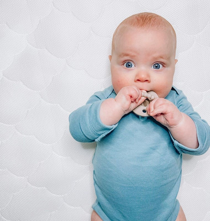 Baby sucking on a teething toy