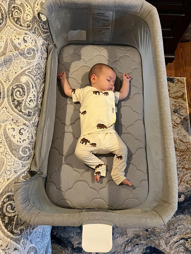 baby sleeping in bassinet