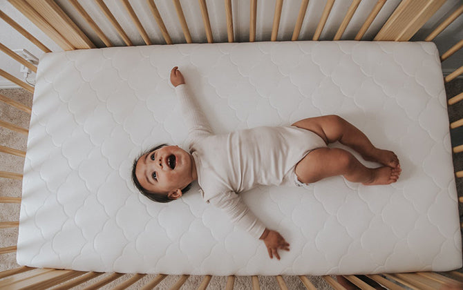 baby looking up in crib