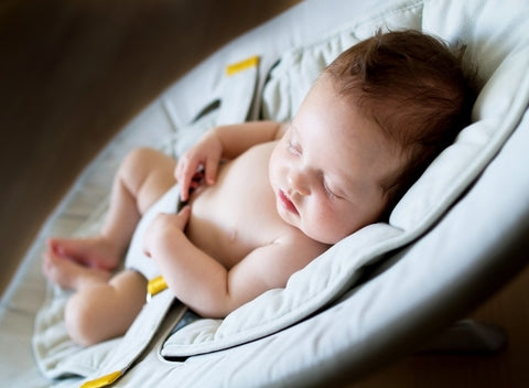 newborn sleeping in bouncer