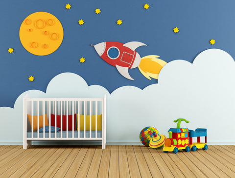space themed baby boy nursery with a rocket ship decal on the wall