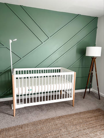 Green accent wall in a baby boy nursery