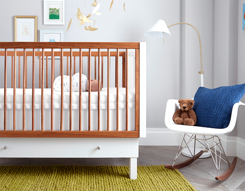 baby boy nursery with a modern crib and rocking chair