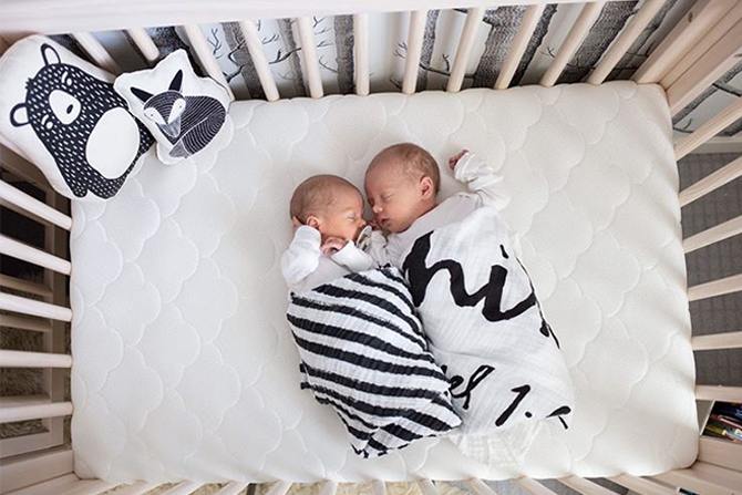 twins sleeping in crib