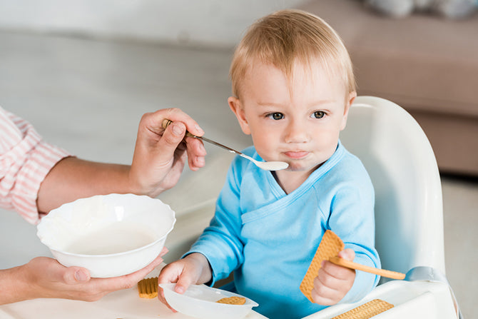 Parent following a baby feeding chart