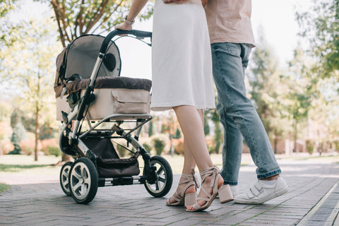 Parents walking baby in stroller