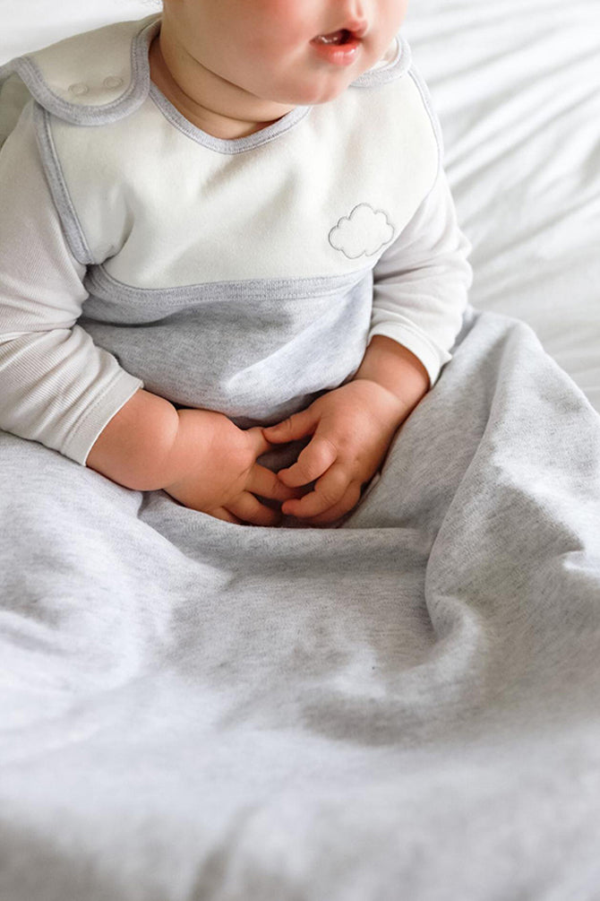 baby sitting in sleep sack