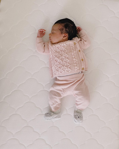 Premium AI Image | Peaceful Sleeping Newborn Baby Girl in a Protected Pose  with Ceiling Projection