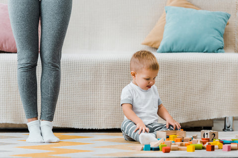 toddler playing with toys after parents did babyproofing 