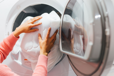 Laundry being loaded into dryer