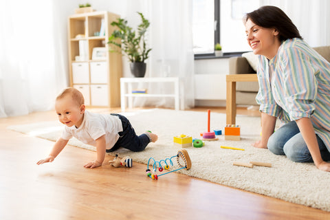 mom playing with son after babyproofing house