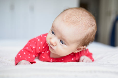 baby laying on bassinet mattress