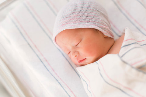 newborn sleeping in crib