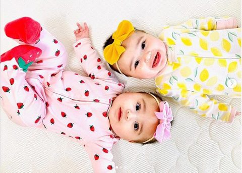 twin baby girls laying together 