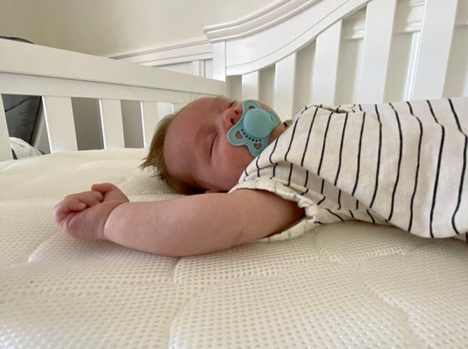 up-close of a baby sleeping with a pacifier