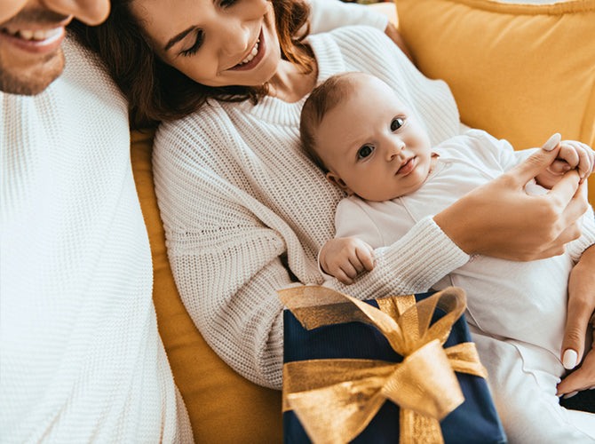 young lovely happy pregnant couple holding a cute baby socks.baby