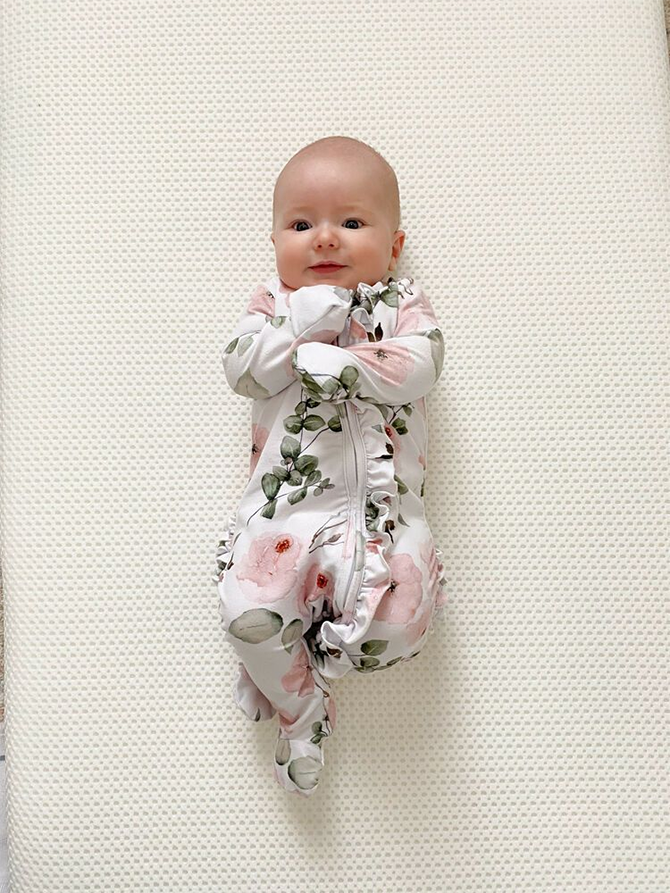 baby wearing cute baby outfit with ruffles and flowers