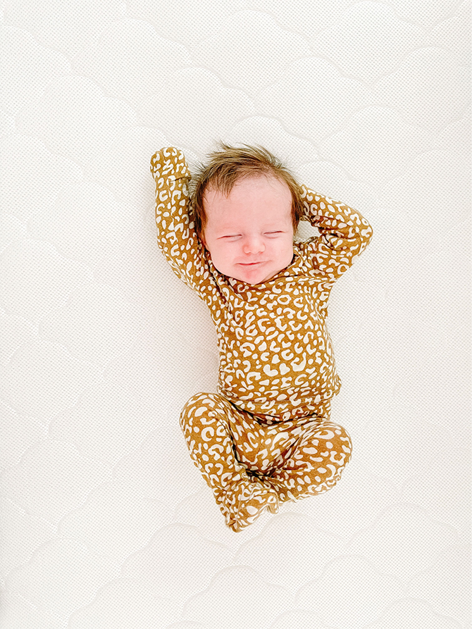 baby stretching in cute baby pajamas