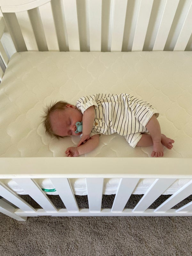 mom learning how to get baby to sleep in crib