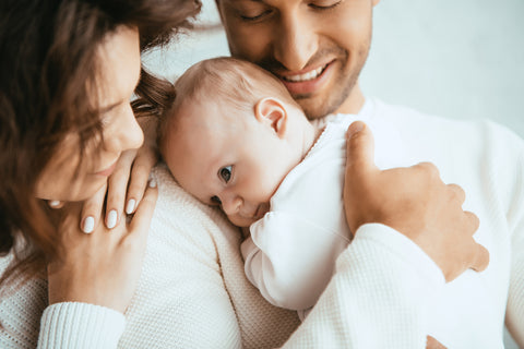 parents holding baby