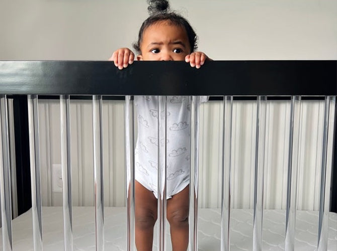 baby standing in a crib