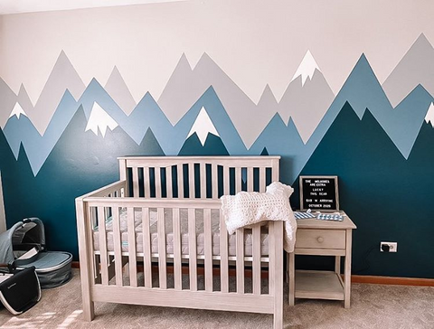 modern nursery idea with painted blue and grey mountains on wall 