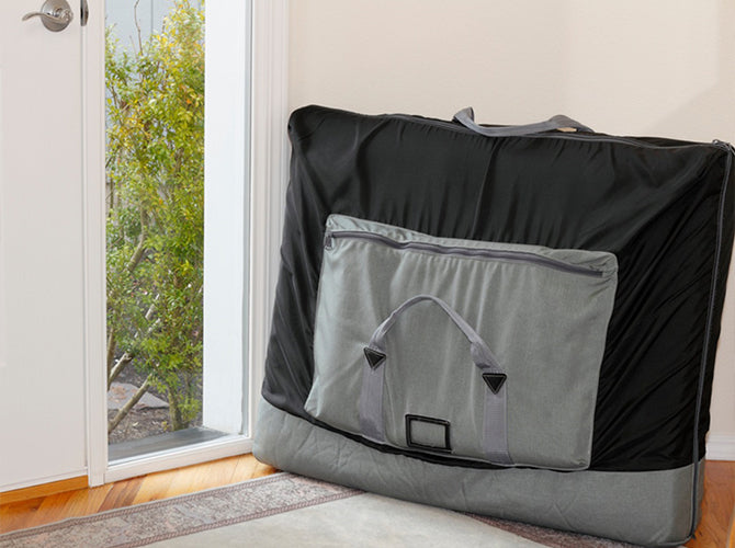 Portable crib in travel case near door