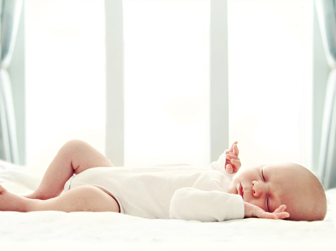 newborn sleeping on back