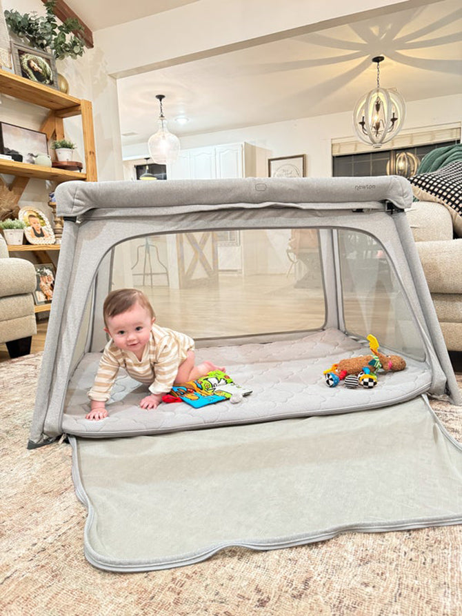 baby playing in play pen