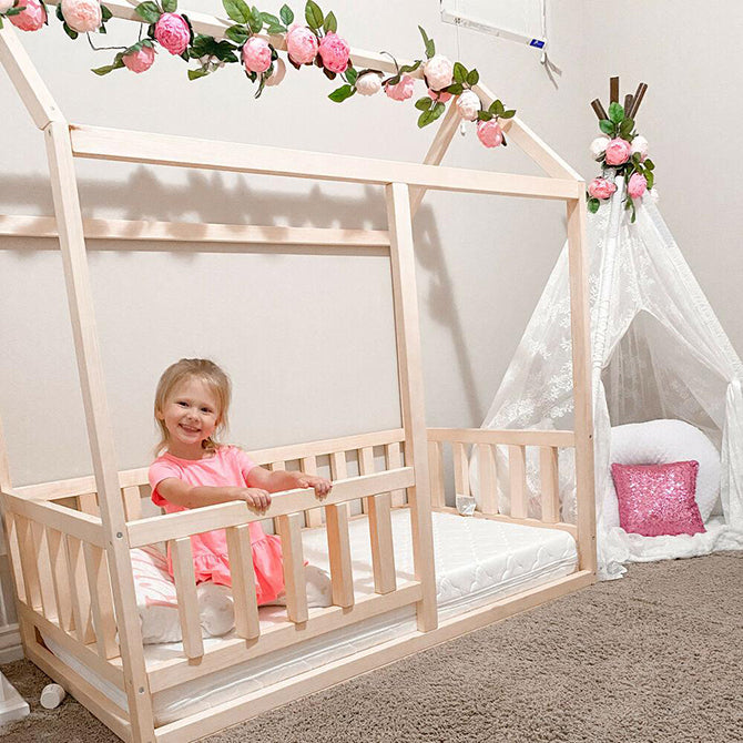 Young girl happy with her new toddler bed