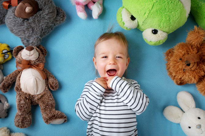 toddler laying with toys