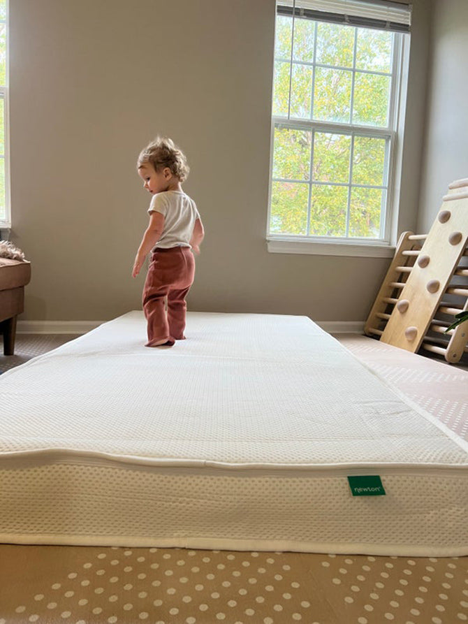 child on a toddler floor bed mattress